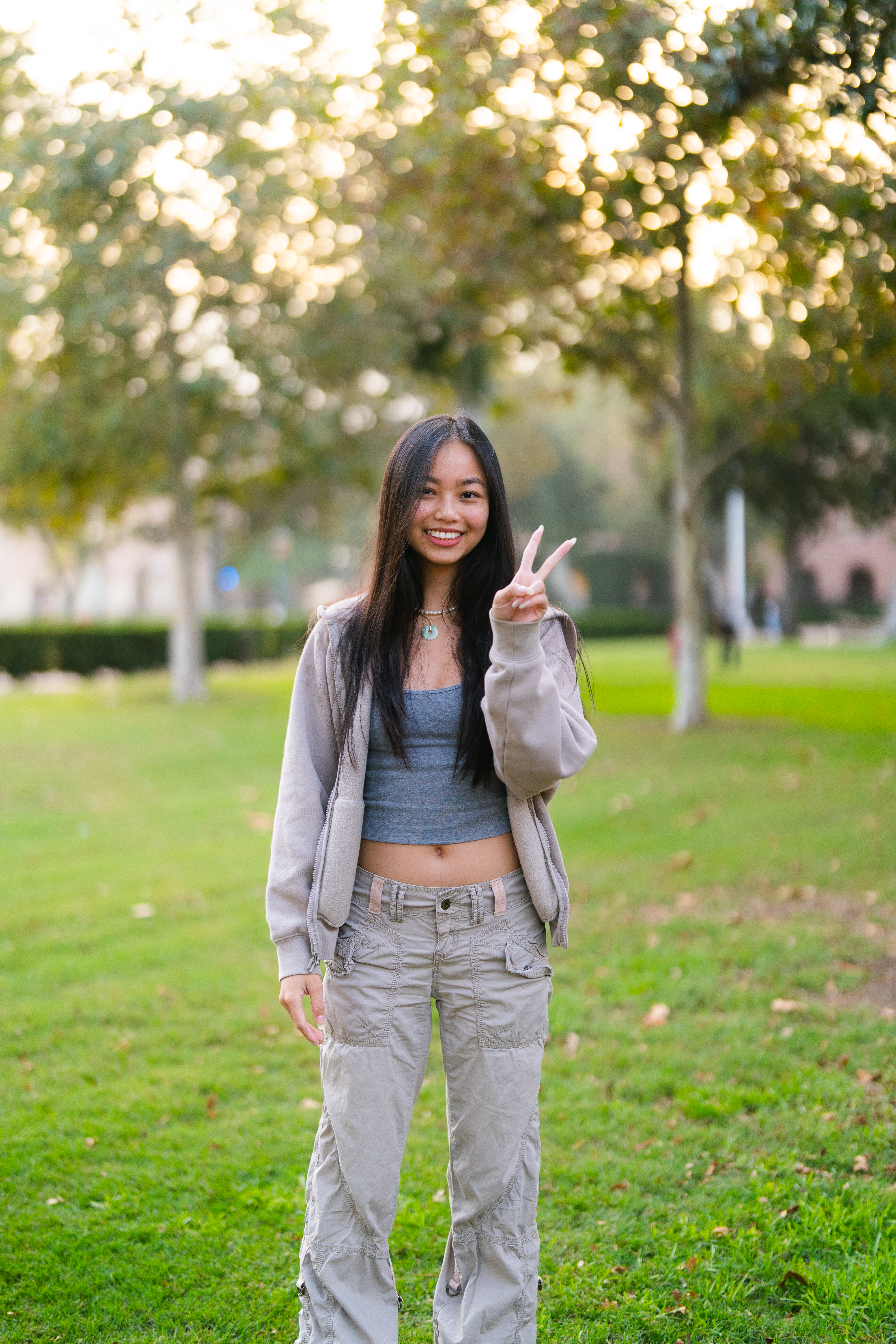 Malia making a peace sign outdoors